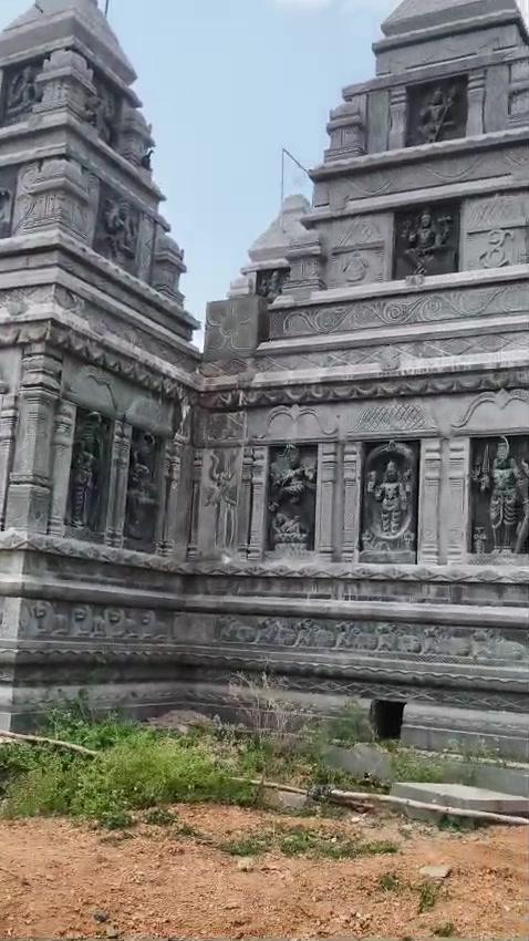 Stone relief panels of deities along the temple wall